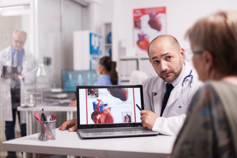 Cardiologist talking with senior patient