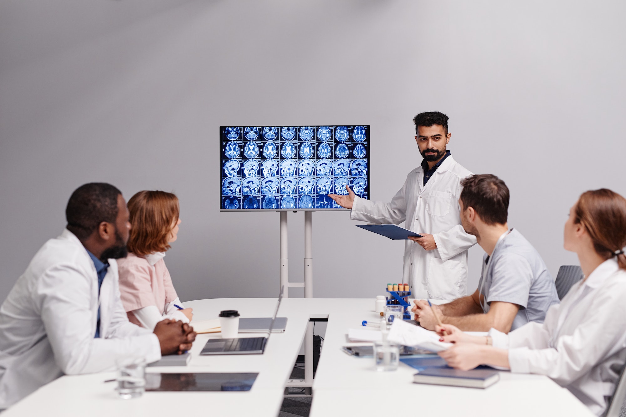 Confident oncologist making presentation of patient mri scan to colleagues