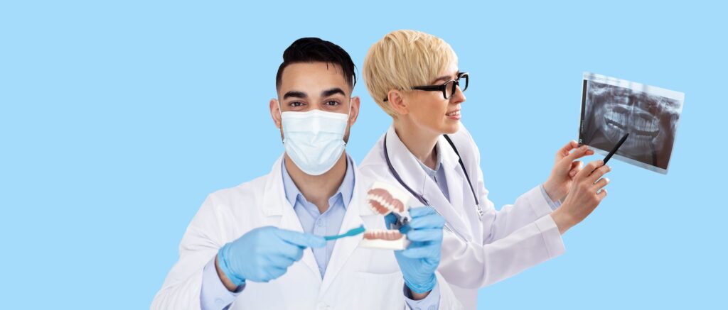 International group of dentists man and woman posing on blue