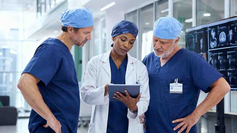 Surgical specialists reviewing clinical information in a modern hospital department